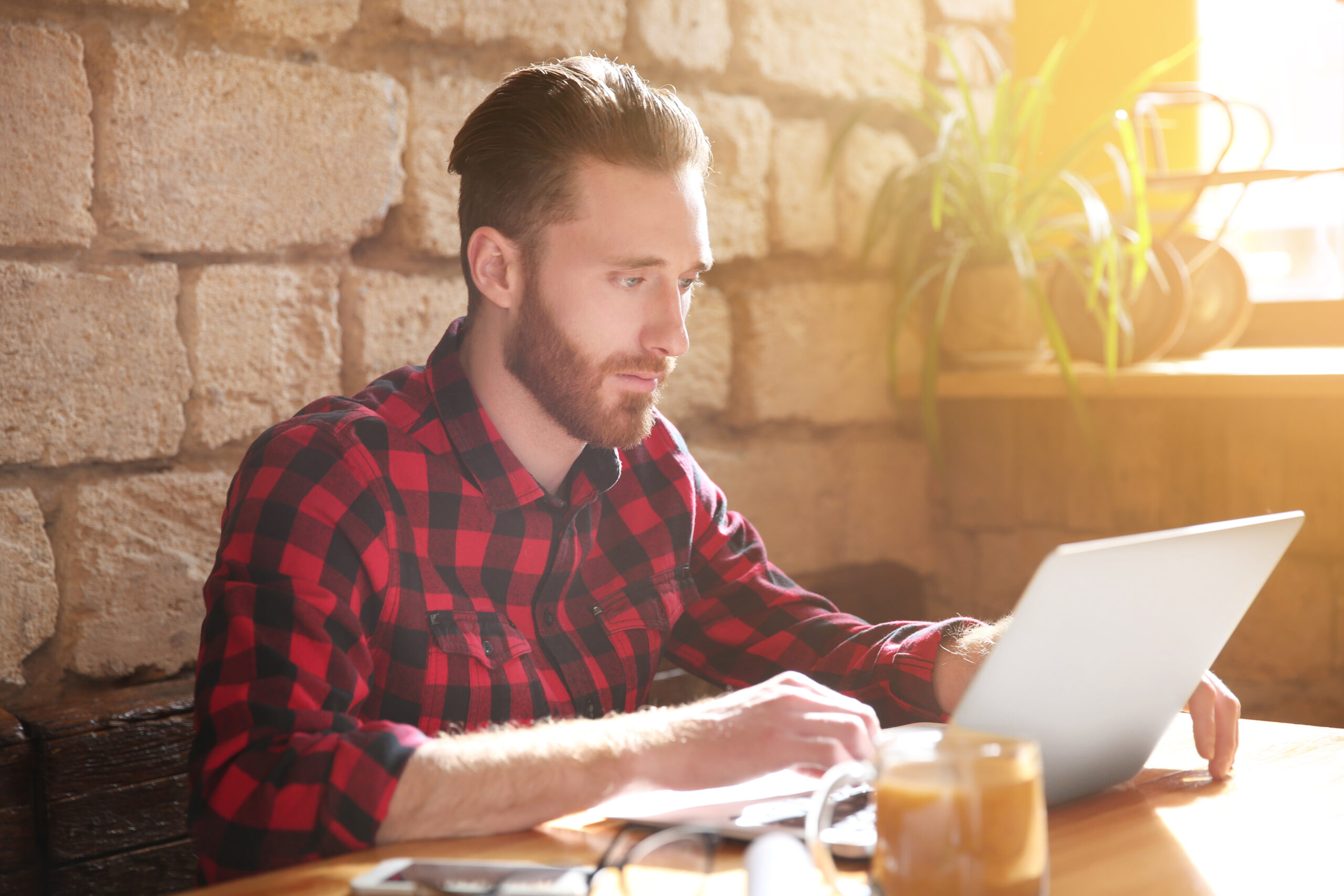 A young man working on laptop at table