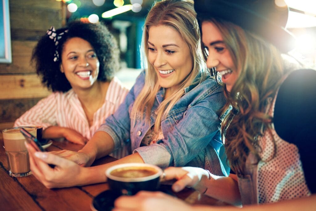 A woman looking happy socialising with friends.