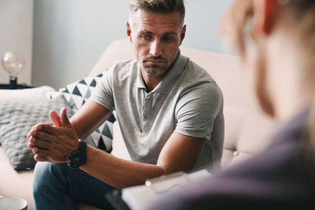 A man looking sad and thoughtful in counselling