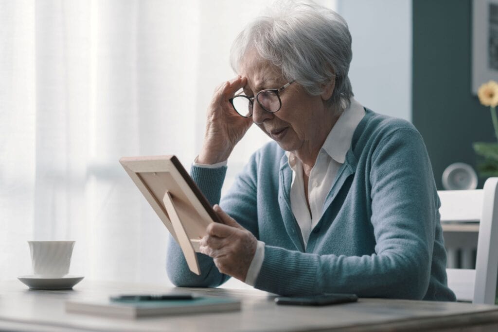 A grieving woman looking at a picture